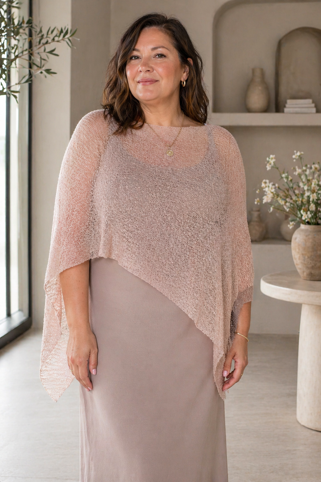 Woman wearing a soft blush Prema Poncho