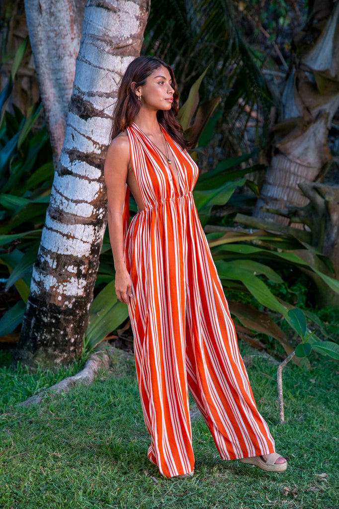 Woman wearing Bali Prema Elizabeth Jumpsuit in Orange Stripe