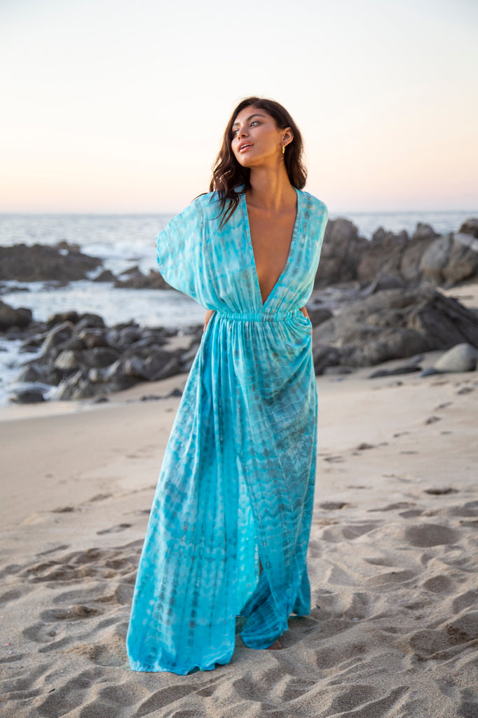 Woman wearing a Amy Kimono Dress in Premium Sophia Loren Turquoise Watercolor on a beach
