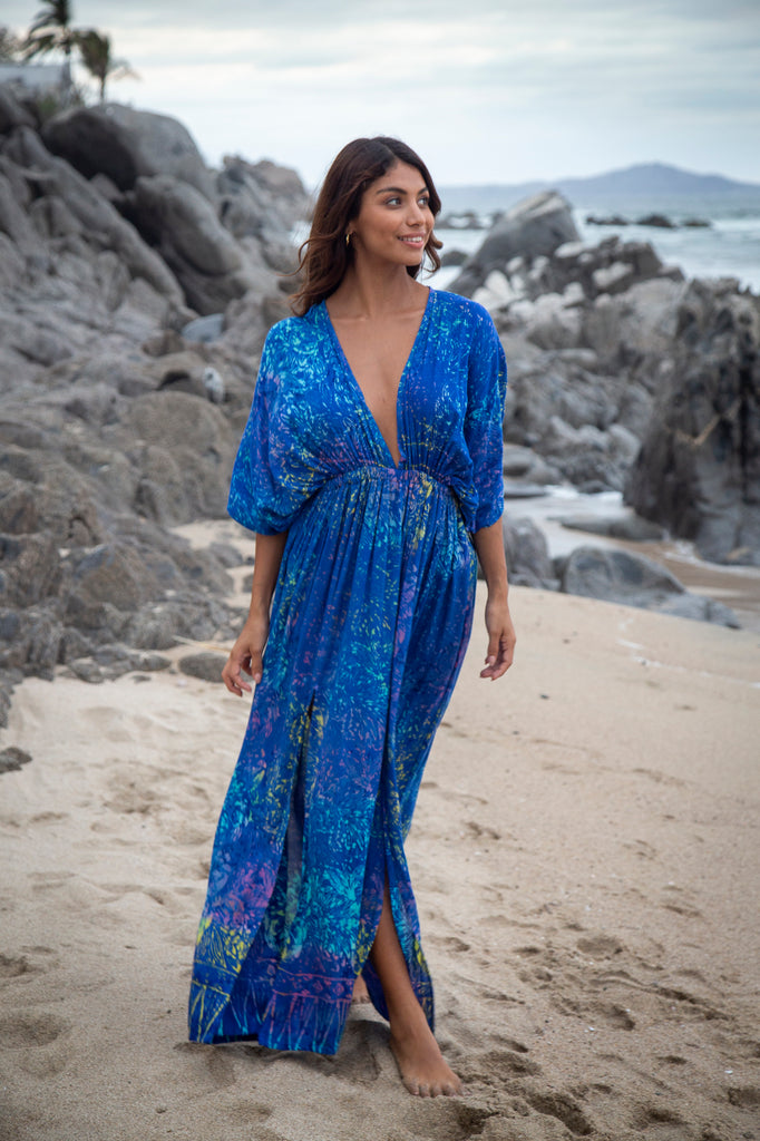 Woman wearing Amy Kimono Maxi Summer Dress - Bahamas Blue Rainbow Batik Sarong on a beach.