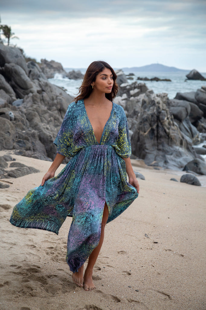 Woman wearing Amy Kimono Maxi Summer Dress - Bahamas Grey Rainbow Batik Sarong on a beach.