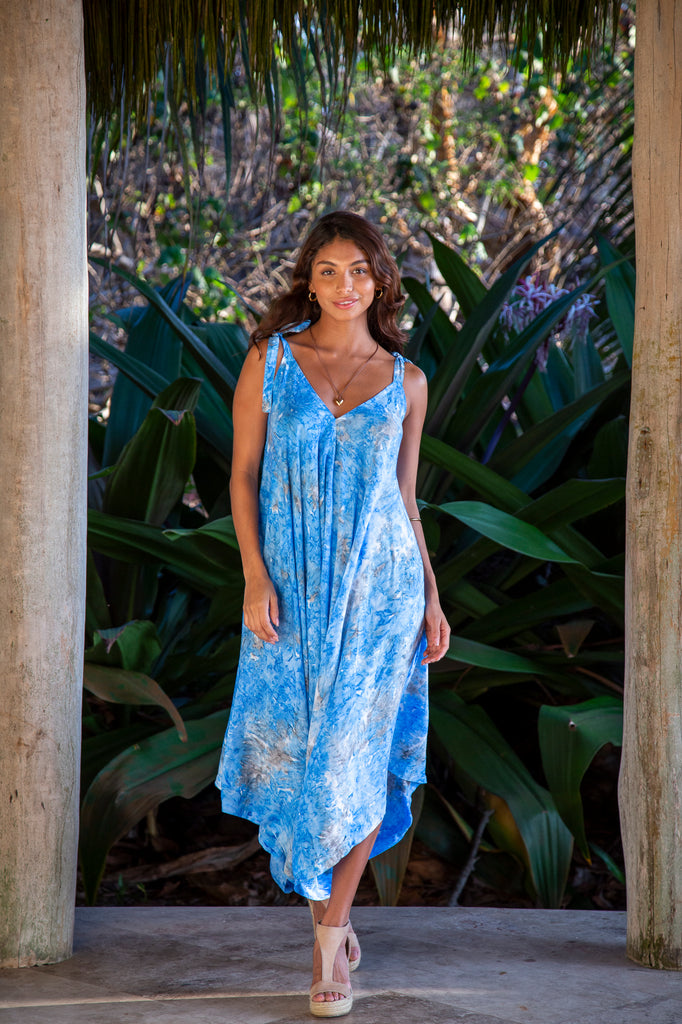 Front of a Woman standing wearing Gypsy Jumpsuit Premium Elizabeth Taylor Blue Watercolor with Pocket OS in front of a forest.