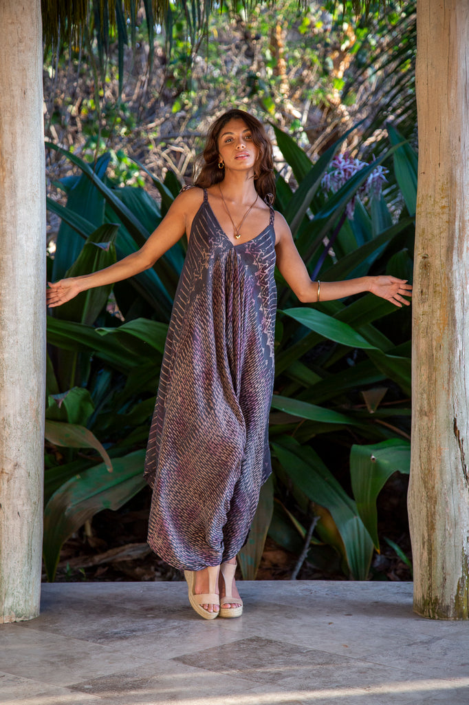 Front of Woman in Gypsy Wide Leg Jumpsuit in Montauk Grey Raindrop in front of a forest.