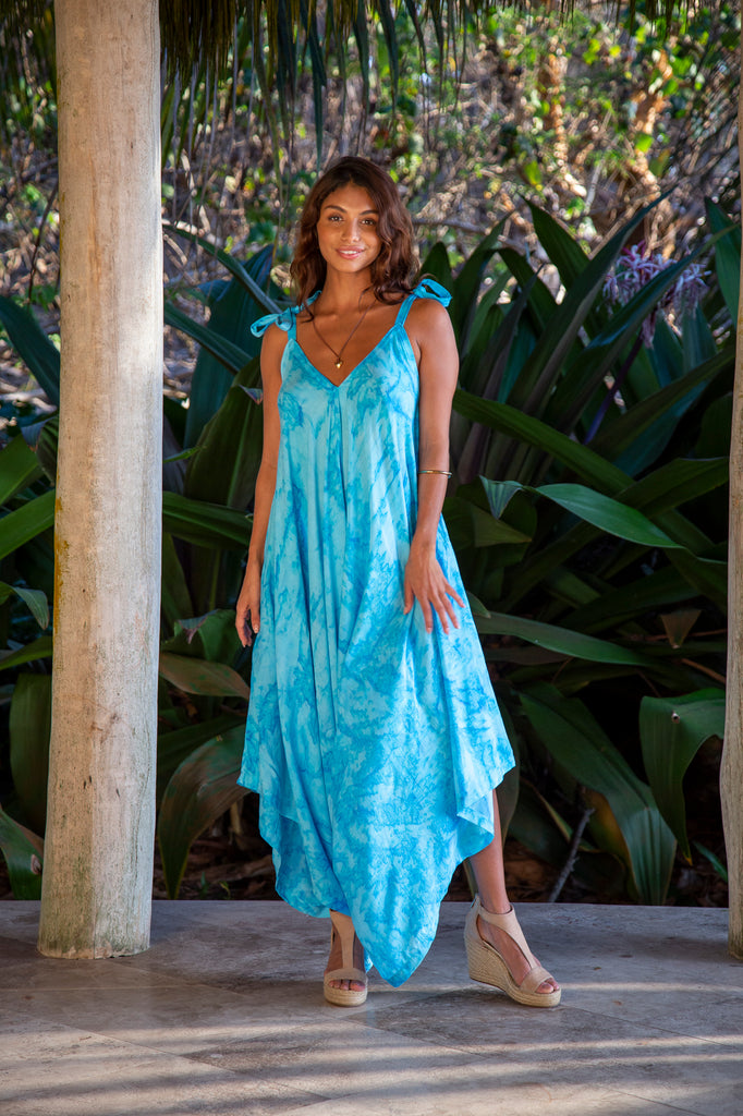 Front of Woman wearing Wide Leg Jumpsuit in Moorea Turquoise Marble in front of a forest.