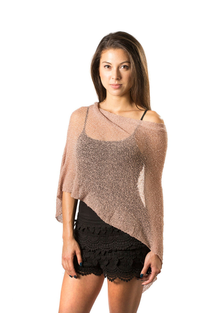 Woman standing upclose wearing Champagne Nude Knit Poncho Shawl over black outfit 