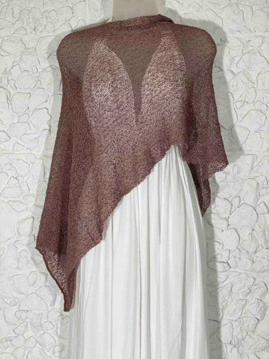 Brown sheer knit poncho shawl dress cover over a white elegant outfit against white background