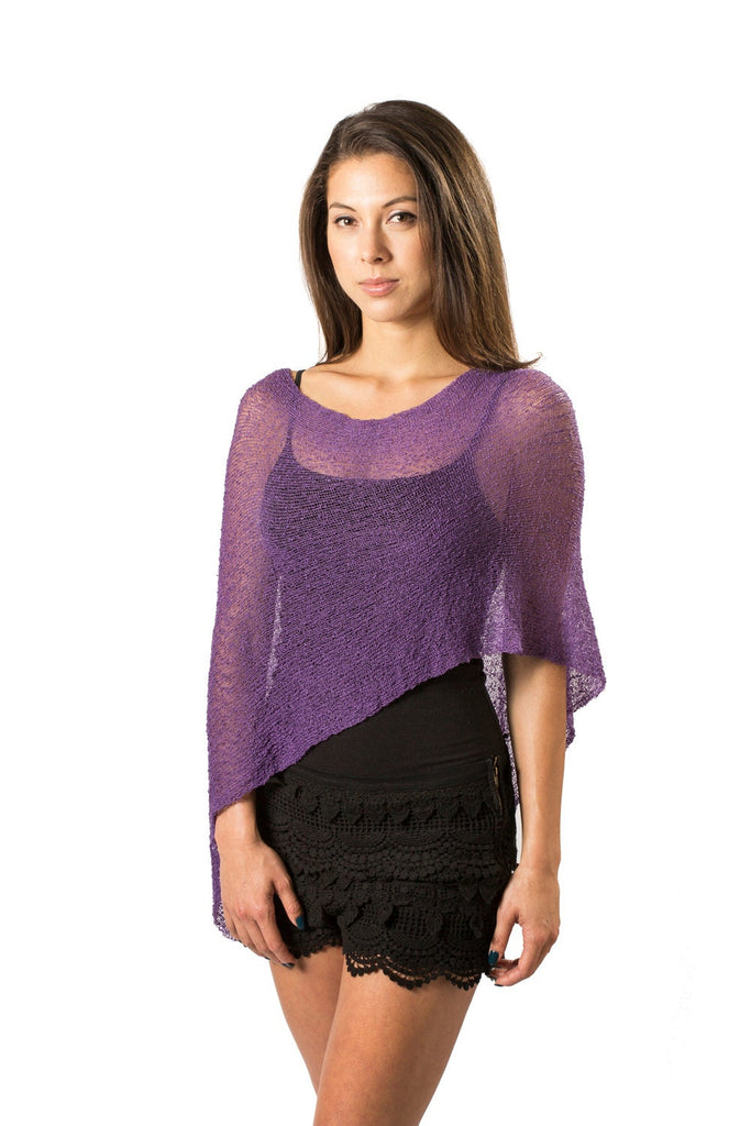 Woman wearing a purple sheer knit lightweight poncho shawl wrap for resort, wedding, beach, nursing, travel, events, over black outfit and white background