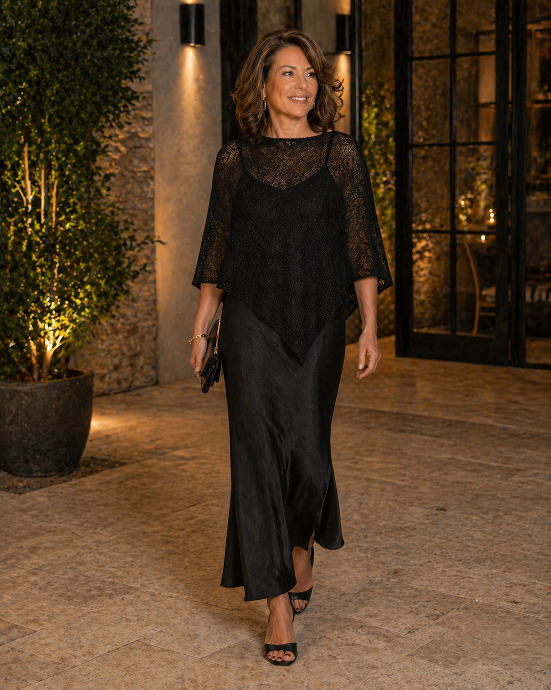 Woman wearing a black Prema Poncho for an evening event